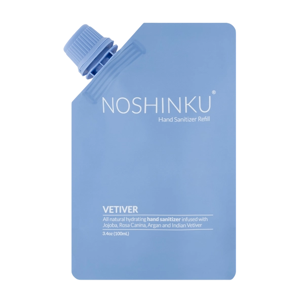 Front-facing product image of the Noshinku Vetiver Hand Sanitizer Refill Pouch in soft blue minimalist packaging with a screw-top refill cap.