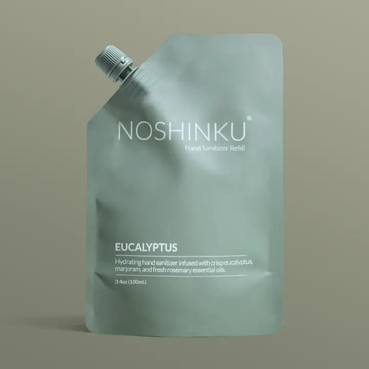 Noshinku Eucalyptus Hand Sanitizer Refill Pouch in muted sage green packaging with a screw cap, featuring a hydrating refill formula infused with eucalyptus essential oils.