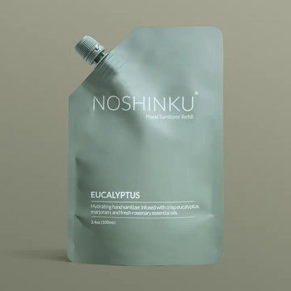 Noshinku Eucalyptus Hand Sanitizer Refill Pouch in muted sage green packaging with a screw cap, featuring a hydrating refill formula infused with eucalyptus essential oils.