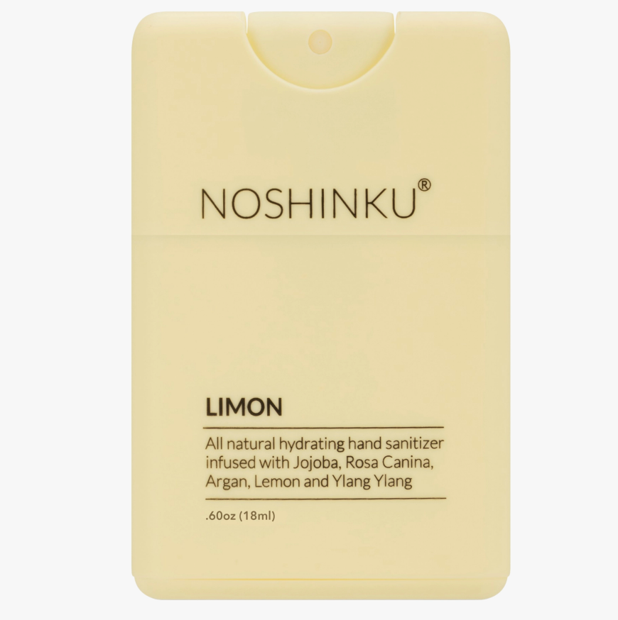 Front-facing product shot of the Noshinku Lemon refillable pocket hand sanitizer spray in a soft pastel yellow bottle with slim minimalist packaging.
